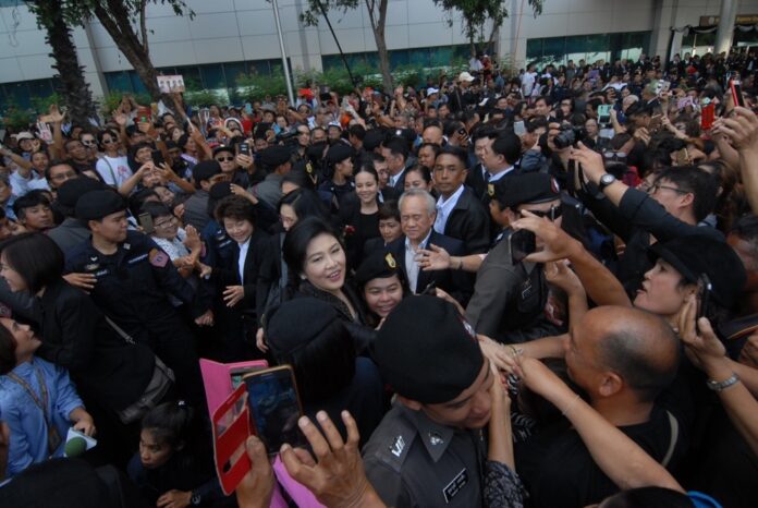 Former premier Yingluck Shinawatra greets supporters Tuesday outside the Supreme Court in Bangkok.