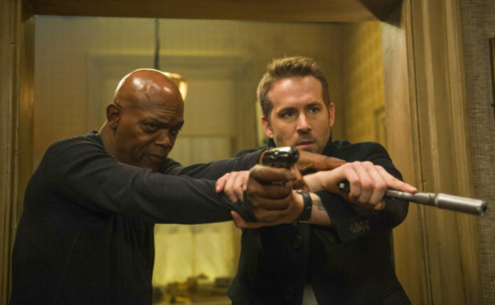 This image released by Lionsgate shows Samuel L. Jackson, left, and Ryan Reynolds in