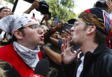 Neo-Nazi Website Founder Says He Fears Returning to US A counterprotester, left, confronts a supporter of President Donald Trump in 2017 at a "Free Speech" rally by conservative activists on Boston Common in Boston, Massachusetts. Photo: Michael Dwyer / Associated Press