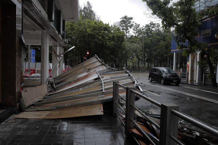 A collapsed wooden wall caused by Typhoon Hato sits Wednesday on a street in Hong Kong. Photo: Vincent Yu / Associated Press