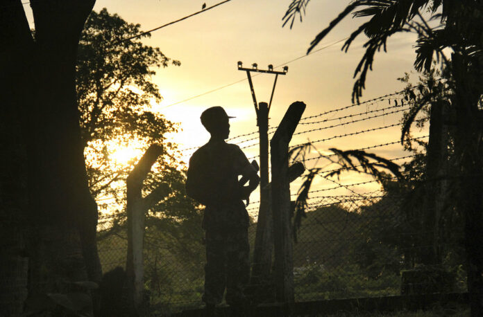 In this Friday, July 14, 2017, photo, a border guard stands at his police post that was previously attacked by a Muslim terrorist group in Kyee Kan Pyin, Buthidaung, Rakhine state Myanmar. Photo: Esther Htusan / Associated Press
