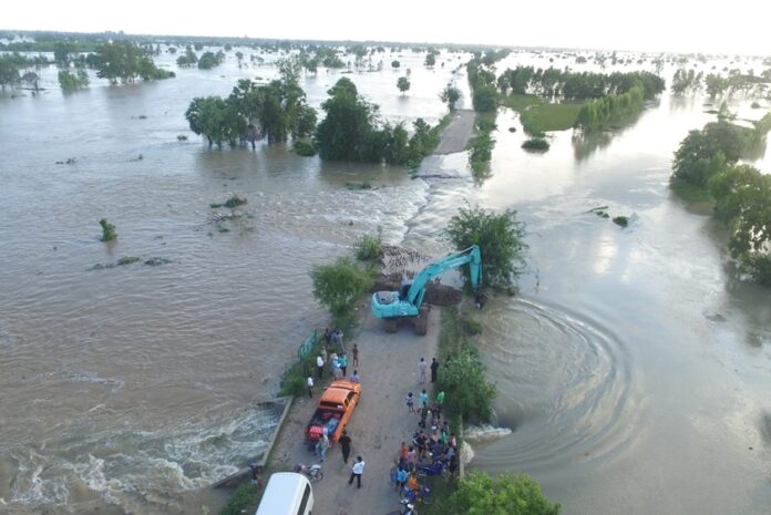 A road crew attempts to repair a road cut off by flood in Buriram Tuesday