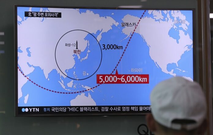 A man watches a TV screen showing a local news program reporting on North Korea's missiles Wednesday at the Seoul Train Station. Photo: Lee Jin-man / Associated Press