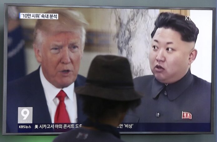 A man watches a television screen showing U.S. President Donald Trump, left, and North Korean leader Kim Jong Un during a news program at the Seoul Train Station, Thursday in Seoul, South Korea. Photo: Ahn Young-joon / Associated Press