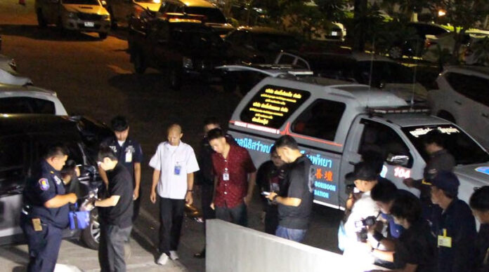 Police, emergency officials and onlookers at the scene where a Korean man fell to his death in Pattaya Thursday.