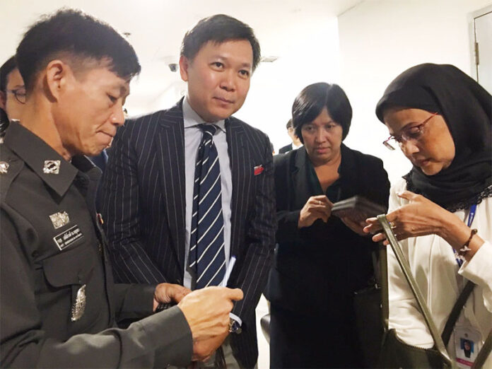 Khaosod English writer Pravit Rojanaphruk, second from left, with police Col. Krit Seneewong na Ayutthaya, far left, Yaowalak Anuphan of Thai Lawyers for Human Rights, second from right, and Angkhana Neelapaijit of the National Human Rights Council, far right, on Aug. 8 at the Technology Crime Suppression Division in Bangkok.
