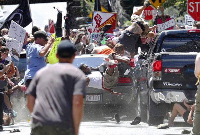 People fly into the air as a vehicle drives into a group of protesters demonstrating against a white nationalist rally Saturday in Charlottesville, Virginia. Photo: Ryan M. Kelly / The Daily Progress