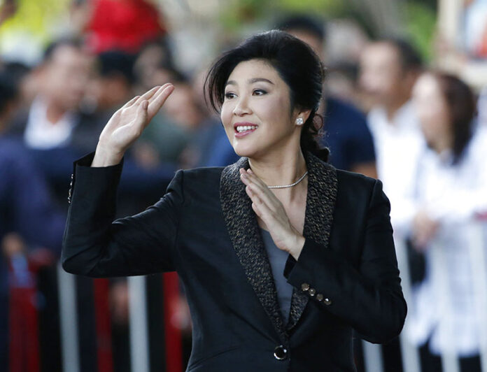 Former Prime Minister Yingluck Shinawatra waves to supporters as she arrives in 2017 to the Supreme Court to make her final statements in a trial on a charge of criminal negligence. Photo: Sakchai Lalit / Associated Press