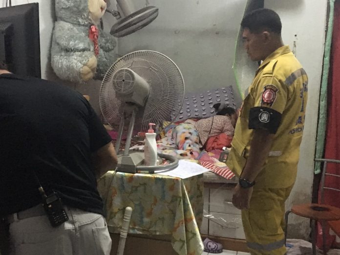 Yolwadee Saikruekam, 52, cries on top of the body of her autistic daughter Chatiya Wongthong, 15, who she confessed to having strangled to death Tuesday in the Chatuchak district.