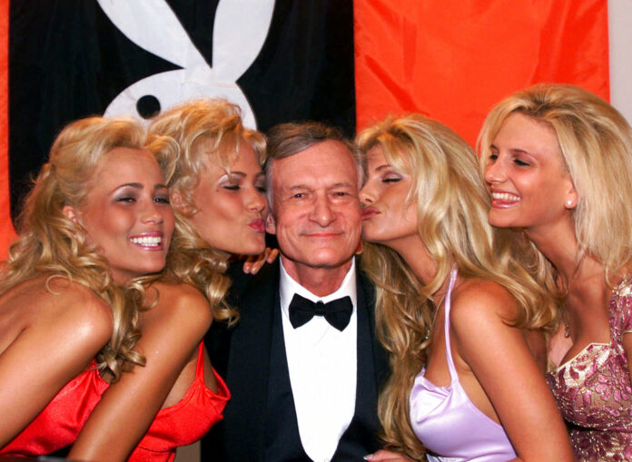 Playboy founder and editor in chief Hugh Hefner receives kisses from Playboy playmates during the 52nd Cannes Film Festival in 1999 in Cannes, France. Photo: Laurent Rebours / Associated Press