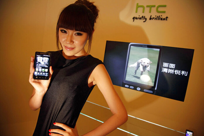 A Chinese model holds up a phone from Taiwan's HTC at a 2010 press conference in Beijing to introduce the brand into China's market. Photo: Ng Han Guan / Associated Press
