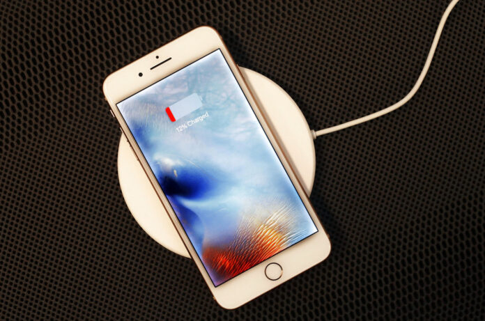 An iPhone 8 Plus rests on a wireless charger Sept. 15 in New York. Photo: Mark Lennihan / Associated Press
