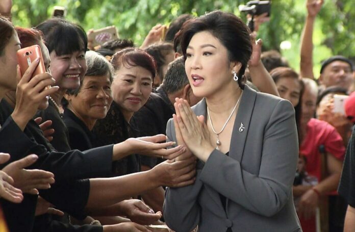 Yingluck Shinawatra greets supporters at the supreme court building in Bangkok on Aug. 22, 2017.