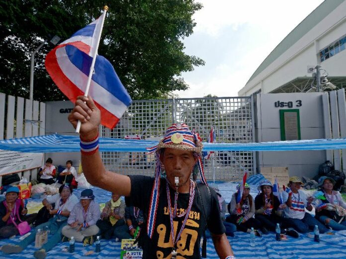 Anti-government protesters on Dec. 32, 2013, block entrance to a registration venue at Din Daeng Stadium for a snap election called by then-prime minister Yingluck Shinawatra
