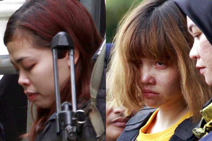 Indonesian suspect Siti Aisyah, left, and Vietnamese suspect Doan Thi Huong, both suspects in the killing of Kim Jong Nam, North Korean leader Kim Jong Un's estranged half brother, are escorted out of court by police officers last March in Sepang, Malaysia. Photo: Daniel Chan / Associated Press