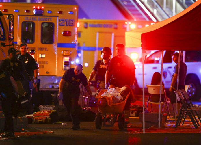 A wounded person is walked in on a wheelbarrow as Las Vegas police respond during an active shooter situation on the Las Vegas Stirp in Las Vegas Sunday, Oct. 1, 2017. Photo: Chase Stevens / Las Vegas Review-Journal