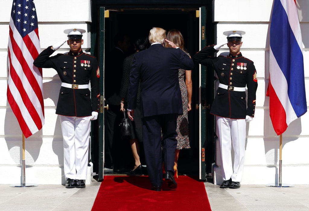 President Donald Trump salutes as he reenters the White House in Washington with first lady Melania Trump on Monday after they greeted Thailand's Prime Minister Prayuth Chan-ocha, and his wife Naraporn Chan-ocha. Photo: Carolyn Kaster / Associated Press