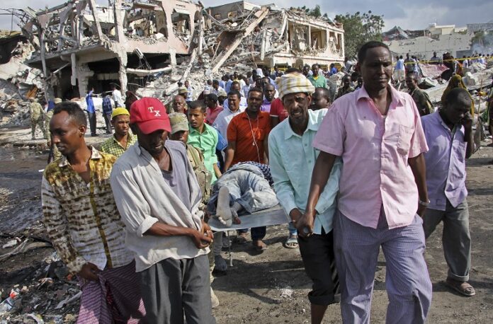 Somalis remove the body of a man killed in Saturday's blast, in Mogadishu, Somalia. Photo: Farah Abdi Warsameh / Associated Press