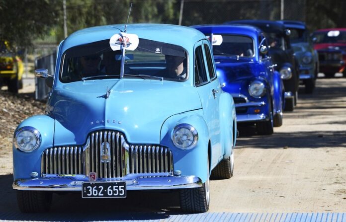 In this Oct. 15, 2017, historic Holden cars parade through the streets of Adelaide, Australia. Photo: David Mariuz / Associated Press