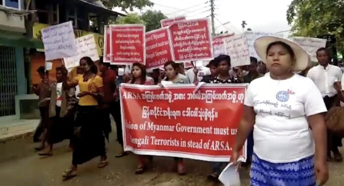 Protesters march Sunday in Sittwe, Myanmar. Image: Associated Press