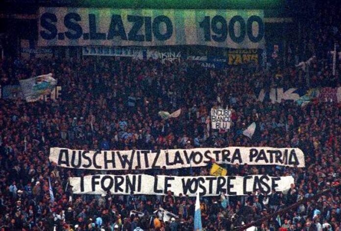 Lazio fans display banners from the stands reading