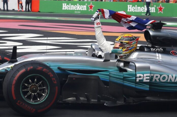 Mercedes driver Lewis Hamilton, of Britain, celebrates at the end of the Formula One Mexico Grand Prix auto race at the Hermanos Rodriguez racetrack Sunday in Mexico City. Photo: Rebecca Blackwell / Associated Press
