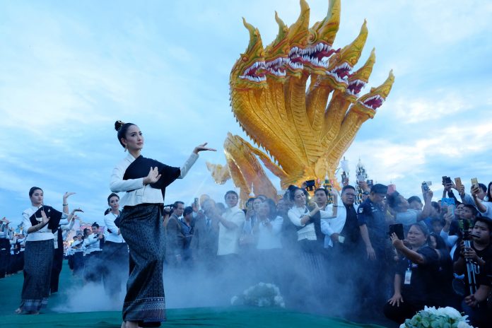 Actress Natapohn ‘Taew’ Tameeruks leads dancers and performers to worship Naga on a riverside in Nong Khai’s Phon Phisai District.
