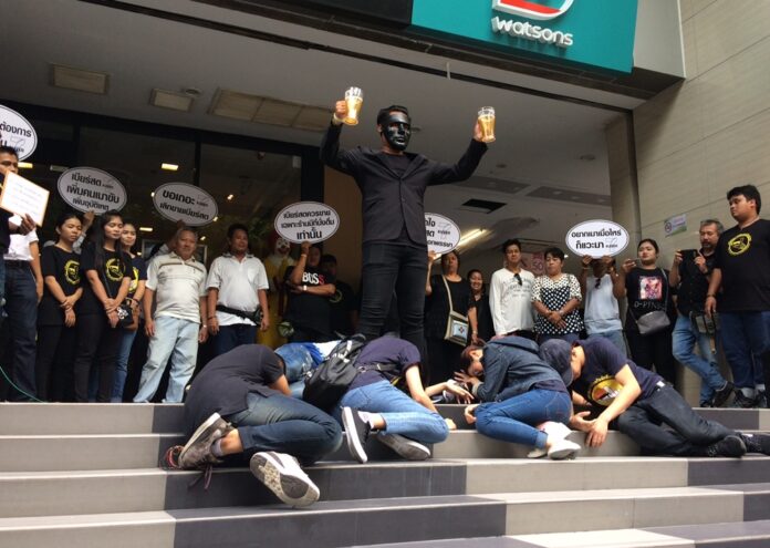 Protesters mock 7-Eleven’s draft beer operation during their Friday’s protest at CP All headquarters in Bangkok