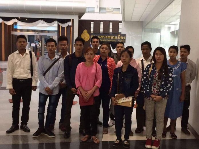 Fourteen migrant workers from Myanmar pose Wednesday in front of Don Mueang Court. Photo: Migrant Workers Rights Network