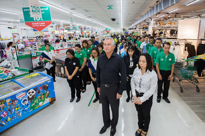 Tesco Lotus CEO John Christie with employees in a publicity photo sent Wednesday.