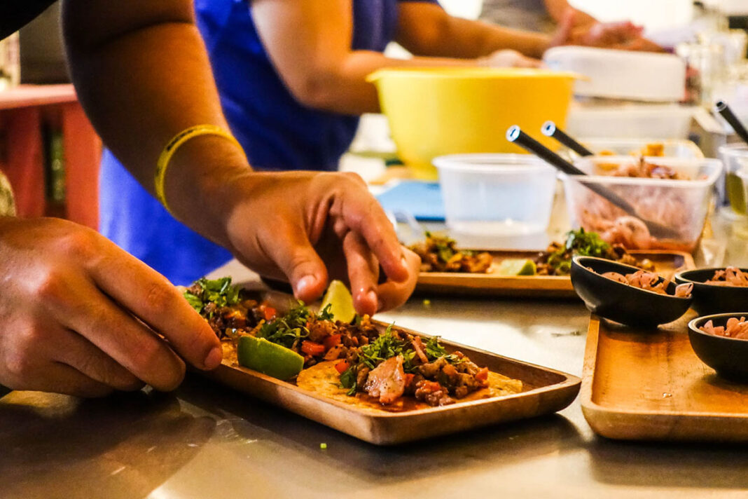 Jimmy Rojas Lopez makes a set of three pork alambre tacos.