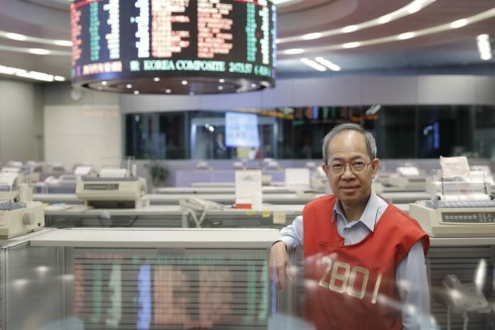 Yip Wing-keung, a trading manager at local brokerage Christfund Securities, wears his red trading jacket in 2017 at the Hong Kong Stock Exchange. Photo: Kin Cheung