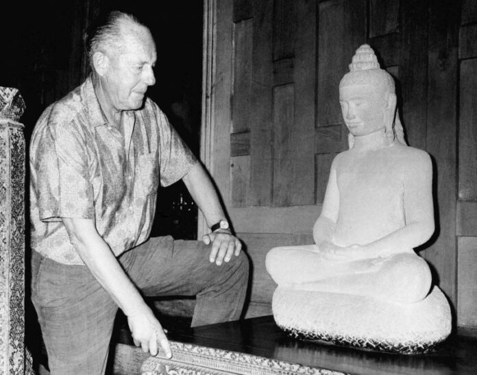 American businessman Jim Thompson views a Buddha statue in November 1966 in Bangkok. Photo: File / Associated Press