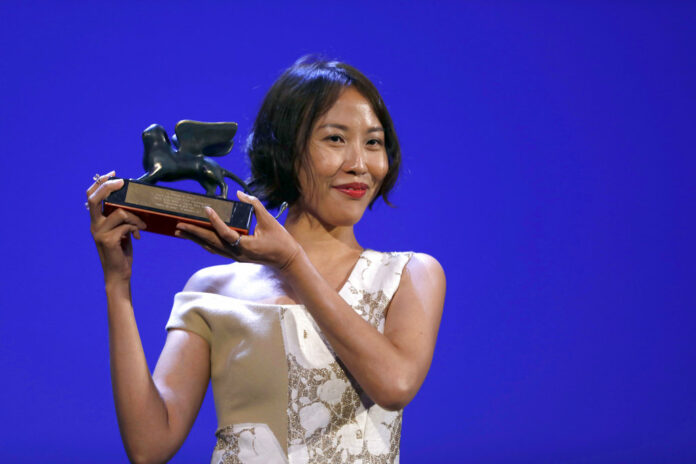 Gina Kim holds the Venice Virtual Reality Prize for best VR story Sept. 9, 2017, at the 74th Venice Film Festival at the Venice Lido. Photo: Domenico Stinellis / Associated Press