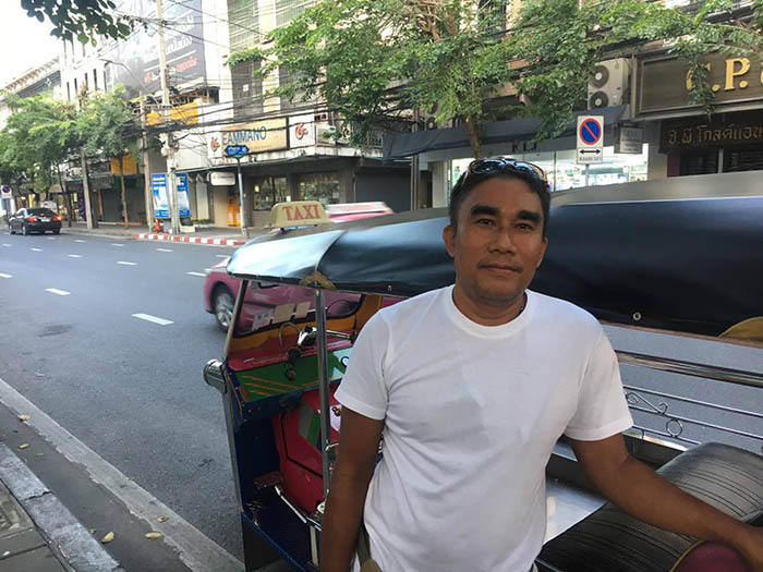 Kamruay Dandongmuang with his tuk-tuk in Bangkok's Bang Rak district.