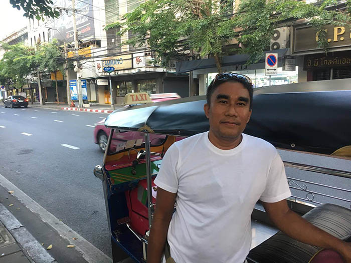Kamruay Dandongmuang with his tuk-tuk in Bangkok's Bang Rak district.