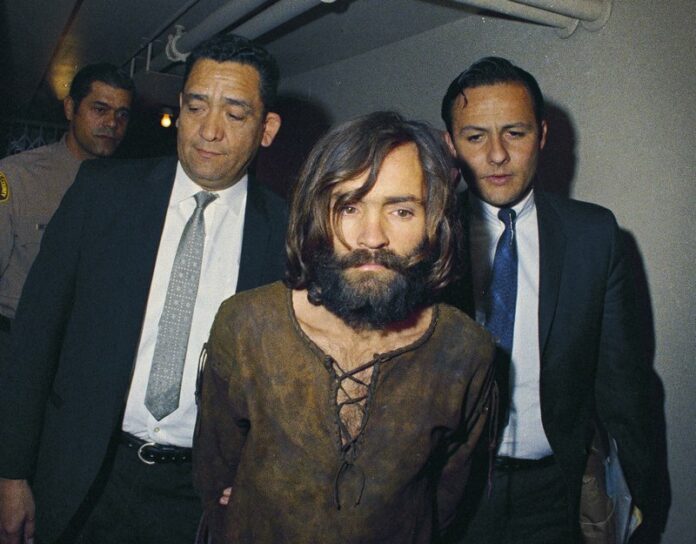 In this 1969 file photo, Charles Manson is escorted to his arraignment on conspiracy-murder charges in connection with the Sharon Tate murder case. Photo: Associated Press