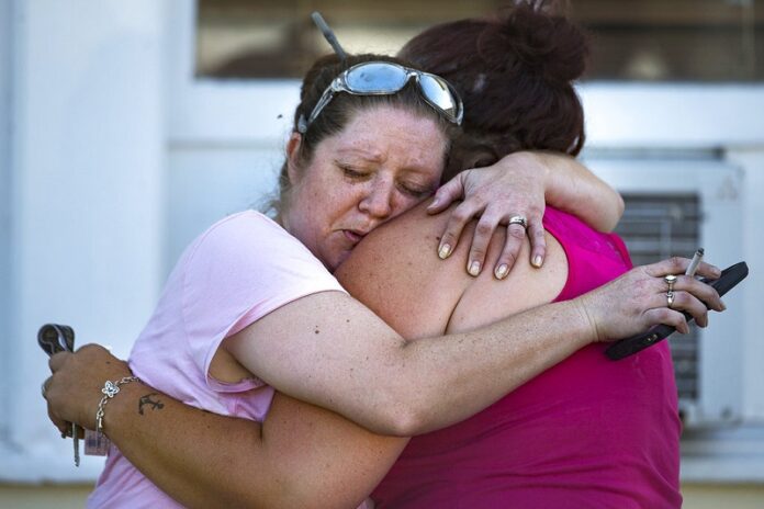 Carrie Matula embraces a woman after a fatal shooting at the First Baptist Church on Sunday in Sutherland Springs, Texas. Photo: Nick Wagner / Associated Press