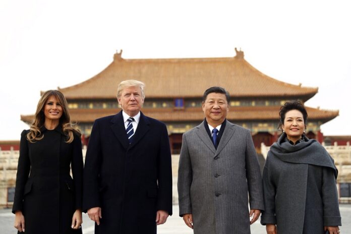 U.S. President Donald Trump, second left, first lady Melania Trump, left, Chinese President Xi Jinping and his wife Peng Liyuan stand together as they tour the Forbidden City in 2017 in Beijing, China. Photo: Andrew Harnik / Associated Press