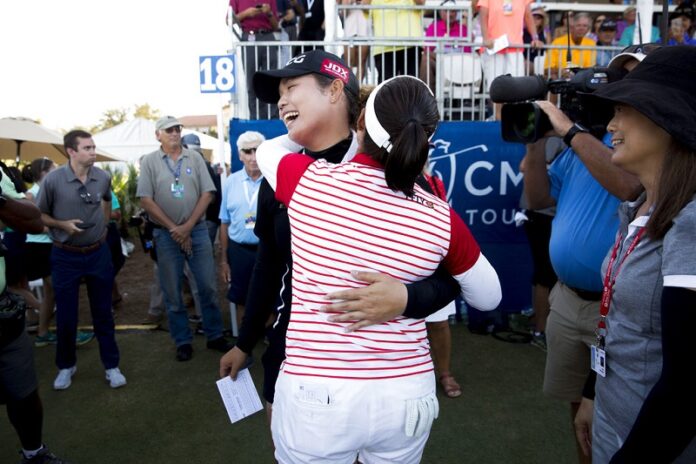 LPGA Tour pro Ariya Jutanugarn is embraced by her sister and fellow pro Moriya Jutanugarn after sinking a birdie putt on the eighteenth hole to claim outright victory during the final round of the CME Group Tour Championship at Tiburón Golf Club Sunday in Naples, Florida. Photo: Luke Franke / Associated Press