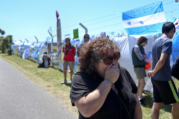 A woman cries in front of a fence enclosing the Mar de Plata Naval Base after learning that Argentina's navy announced that a sound detected during the search for the missing ARA San Juan submarine is consistent with that of an explosion, Thursday in Mar de Plata, Argentina. Photo Esteban Felix / Associated Press