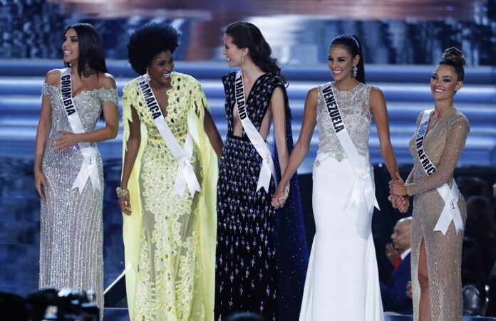 From left, final five finalists Miss Colombia Laura Gonzalez, Miss Jamaica Davina Bennett, Miss Thailand Maria Poonlertlarp, Miss Venezuela Keysi Sayago and Miss South Africa Demi-Leigh Nel-Peters stand on stage at the Miss Universe pageant Sunday in Las Vegas. Photo: John Locher / Associated Press