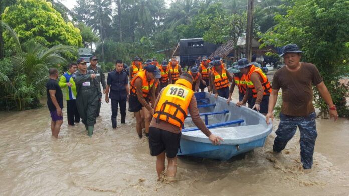 Naval officers push a boat to evacuate residents Wednesday in Prachuap Khiri Khan province.