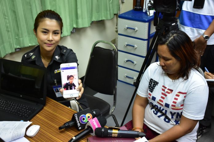 Police Lt. Col. Raktapa Wongyod displays a fake Facebook profile with her photo next to the alleged perpetrator Angkhana Danakam on Thursday morning at Bang Khen police station.