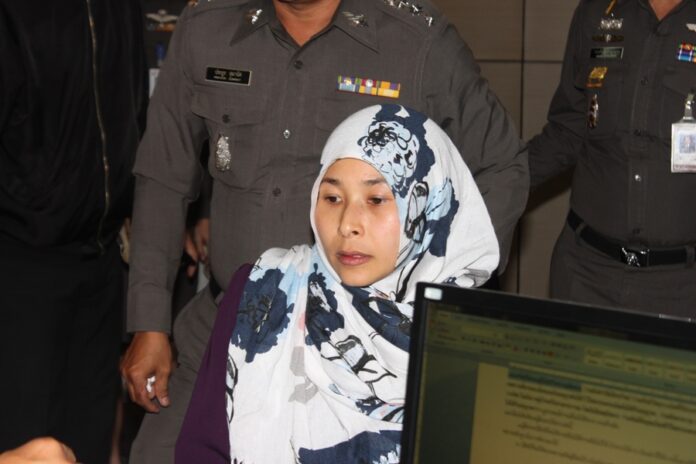 Police question Wanna Suansan on Wednesday evening in Bangkok.