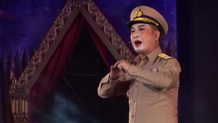 An actor from the Chae Lung Ngek Lao Choon troupe performs as a policeman Monday at Bangkok’s Sanam Luang.