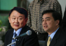 Thai Political Enemies Weigh Alliance to Defeat Junta A completely fake image of Democrat Party leader Abhisit Vejjajiva, at right, with de facto Pheu Thai leader, fugitive former Prime Minister Thaksin Shinawatra.