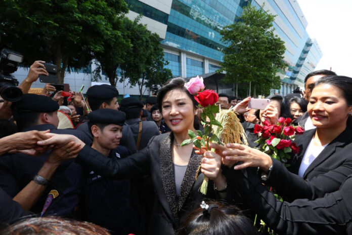 Yingluck Shinawatra greets her supporters in front of the court on Aug. 1.