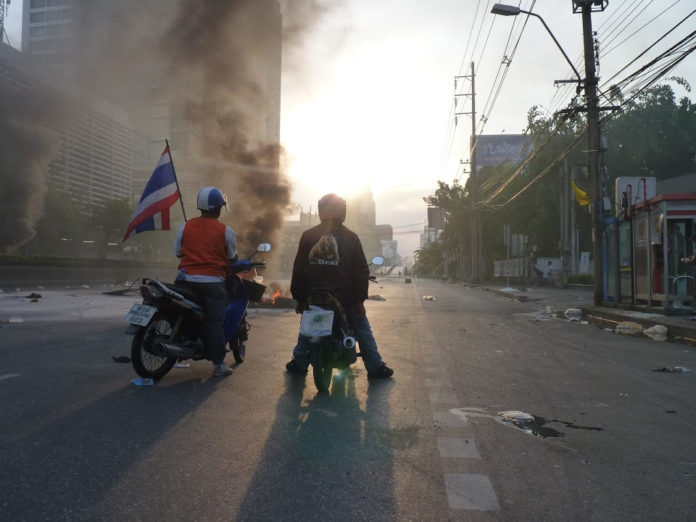 Community members and Redshirt supporters massed near an army cordion on May 14, 2010. Minutes later, a young soldier opened fire on the crowd, killing a civilian.