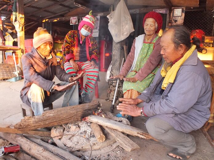 Korat residents huddle around a campfire Thursday morning.